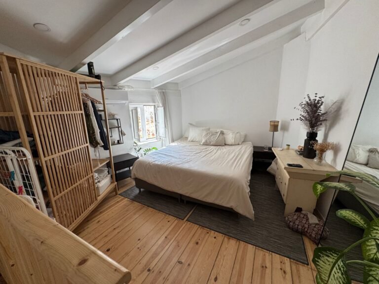 Bright bedroom in a Lisbon sublet with open storage and natural light