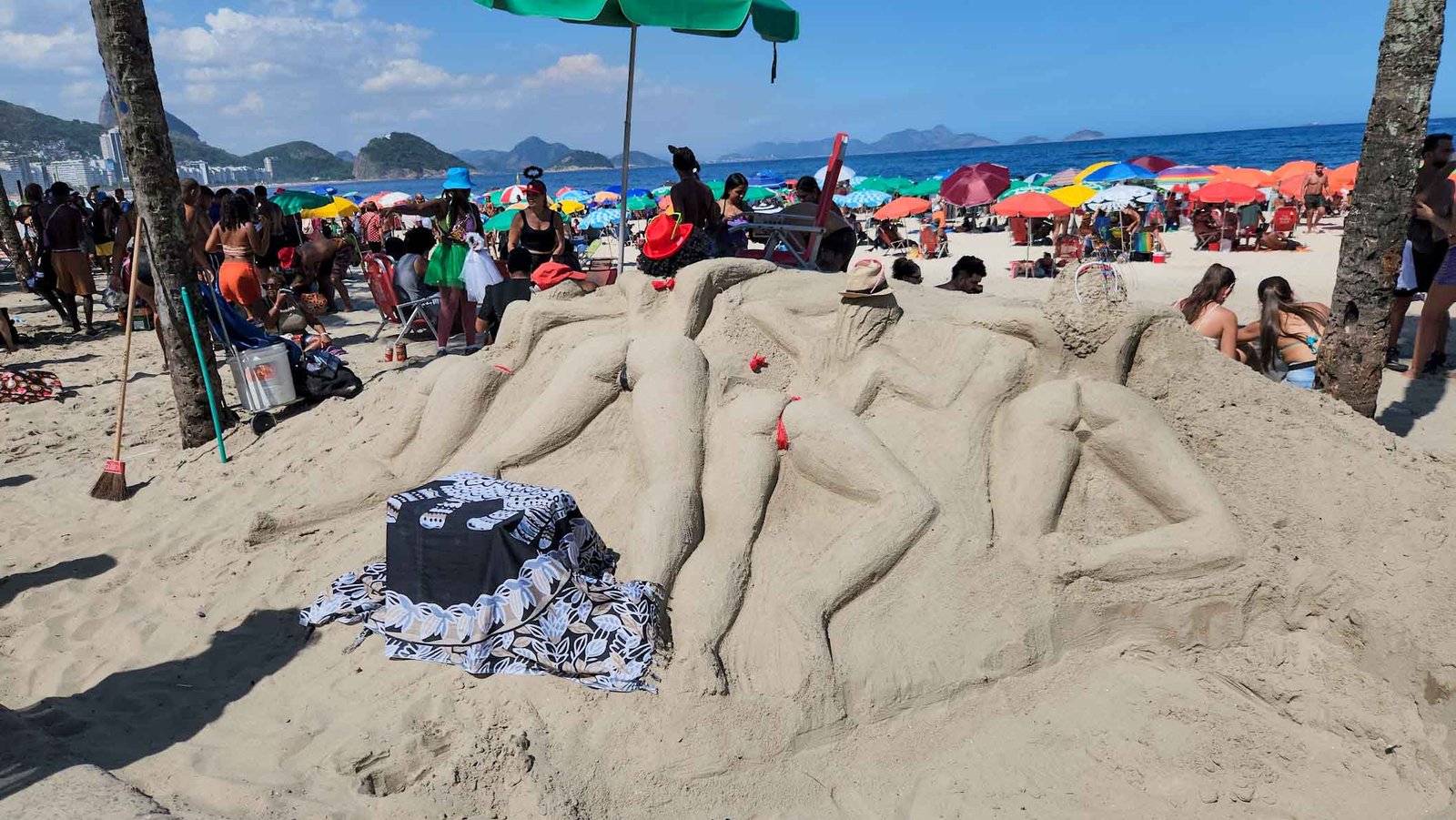 Carnival sand sculpture and beachgoers on Copacabana Beach