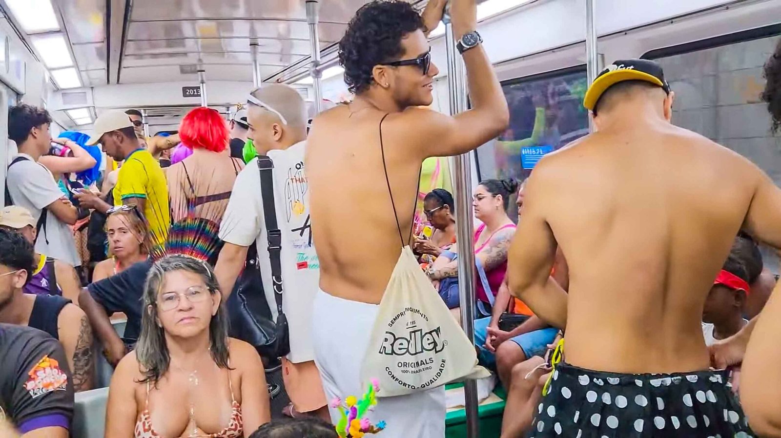 Carnival revelers traveling in a crowded Rio de Janeiro metro carriage