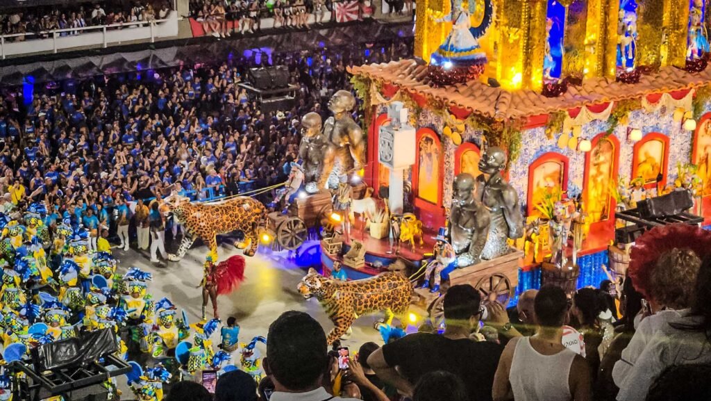 Illuminated Carnival float with jaguar sculptures and performers at Rio's Sambadrome