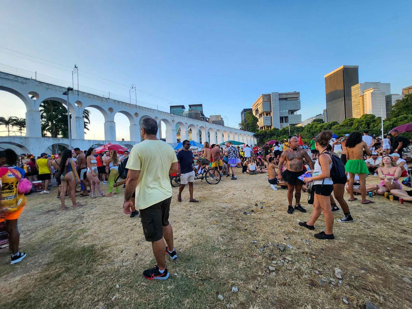 Carnival crowds beside the white arches of Lapa in Rio de Janeiro